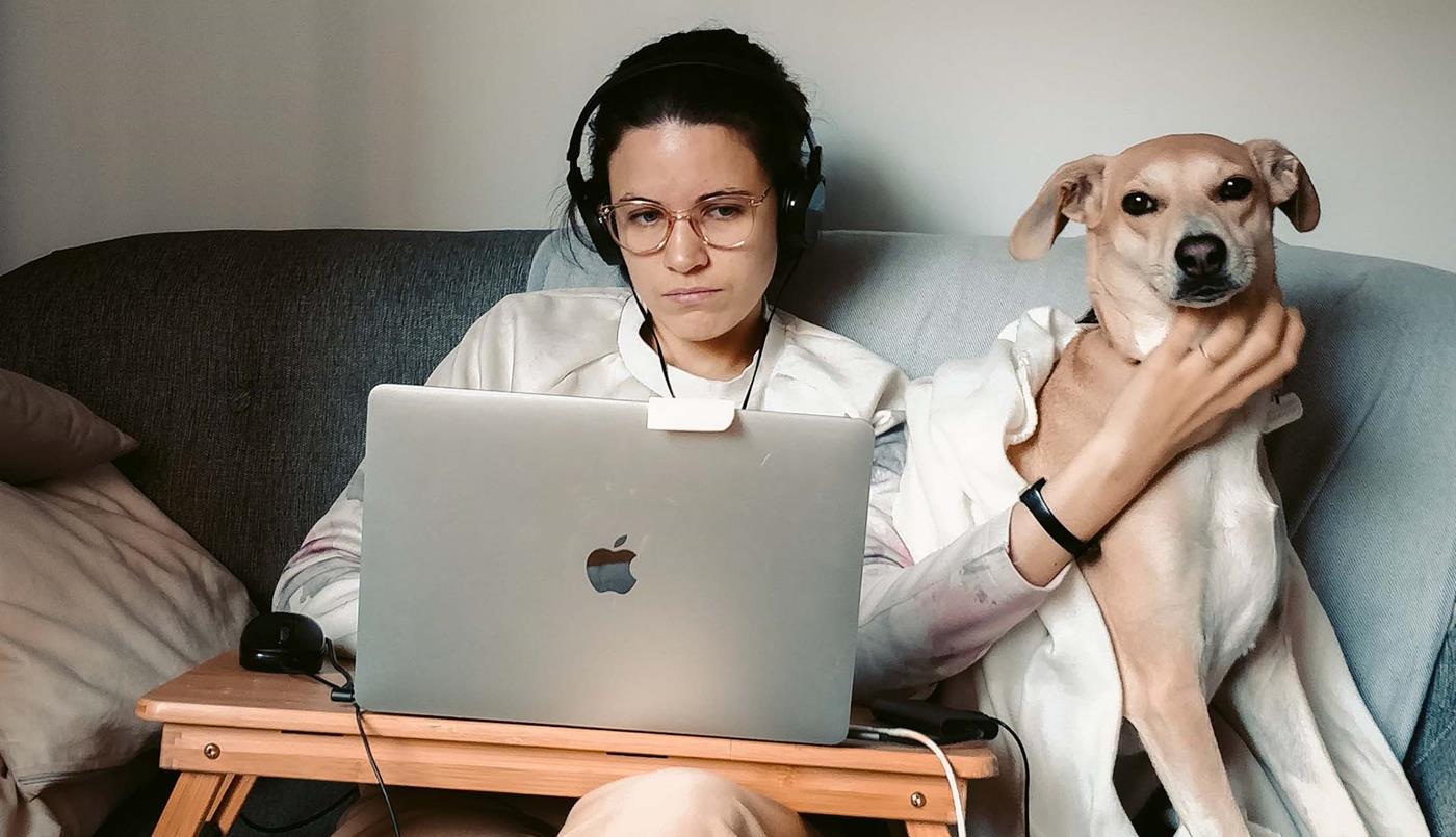 Woman on laptop with dog