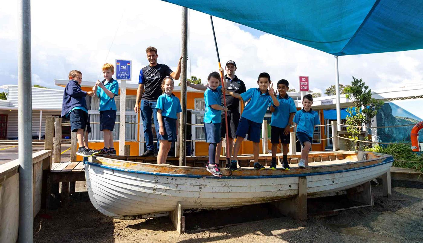 ETNZ team standing on boat with students at Arahoe School