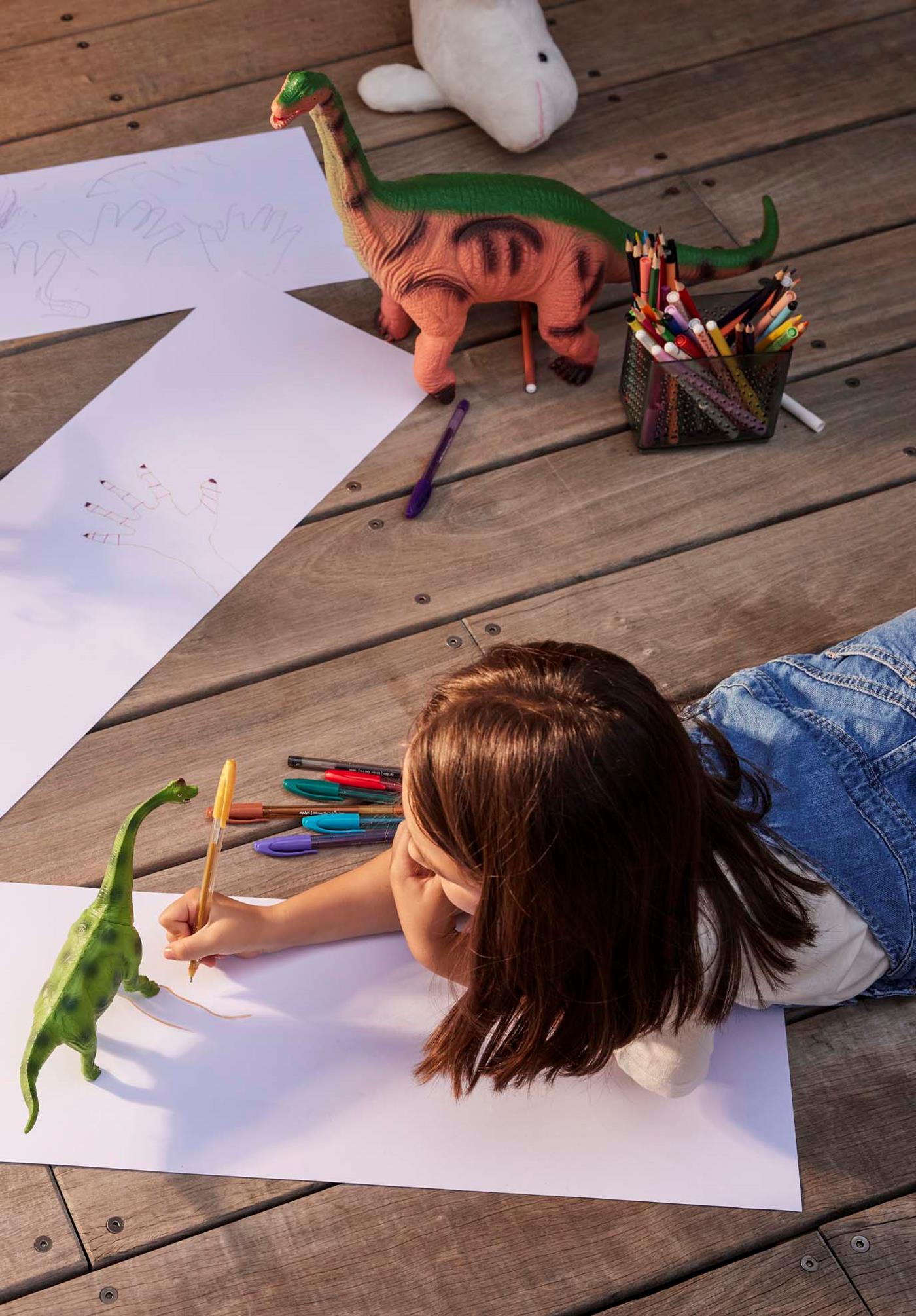 Child drawing dinosaurs