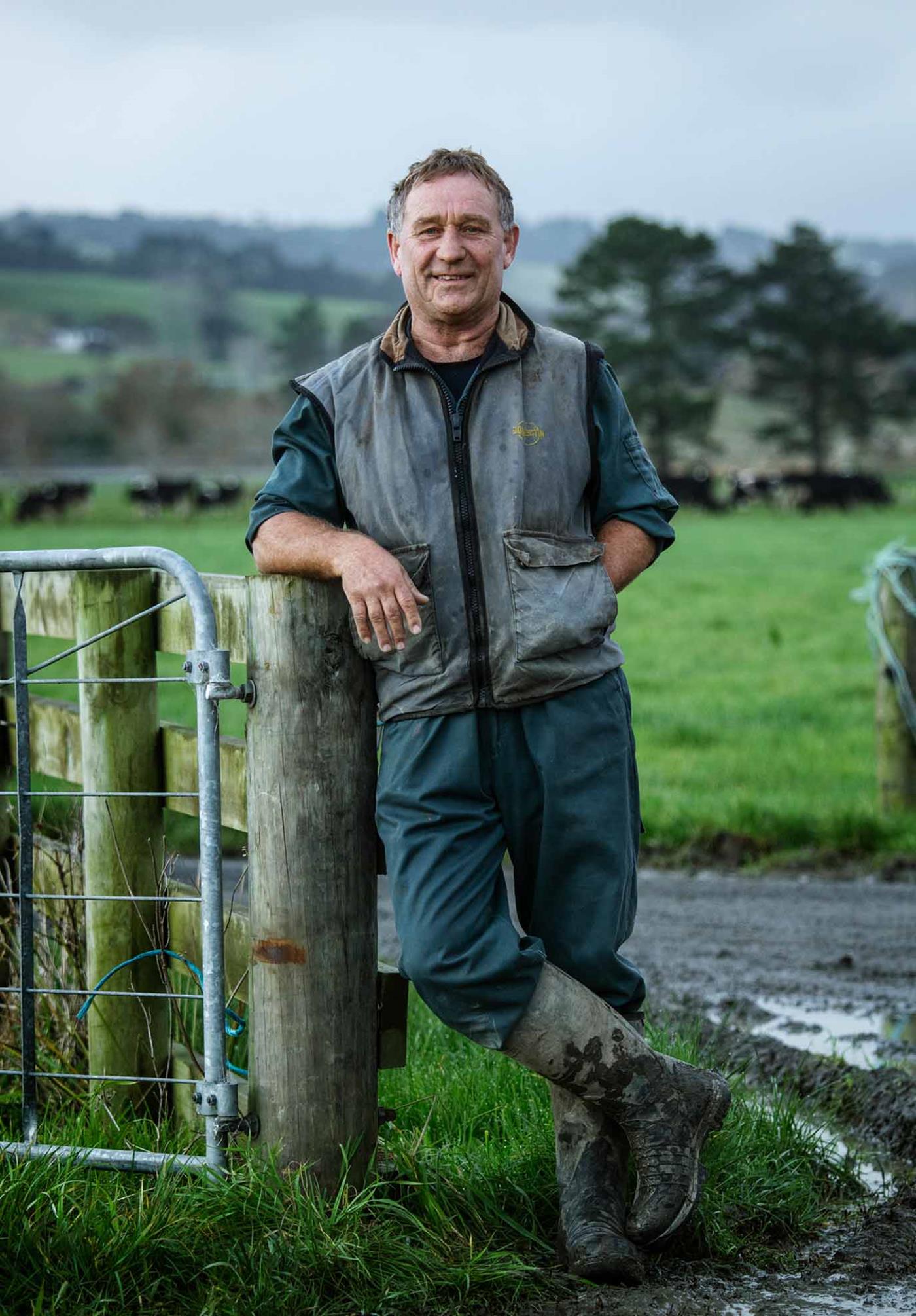 farmer leaning on fence
