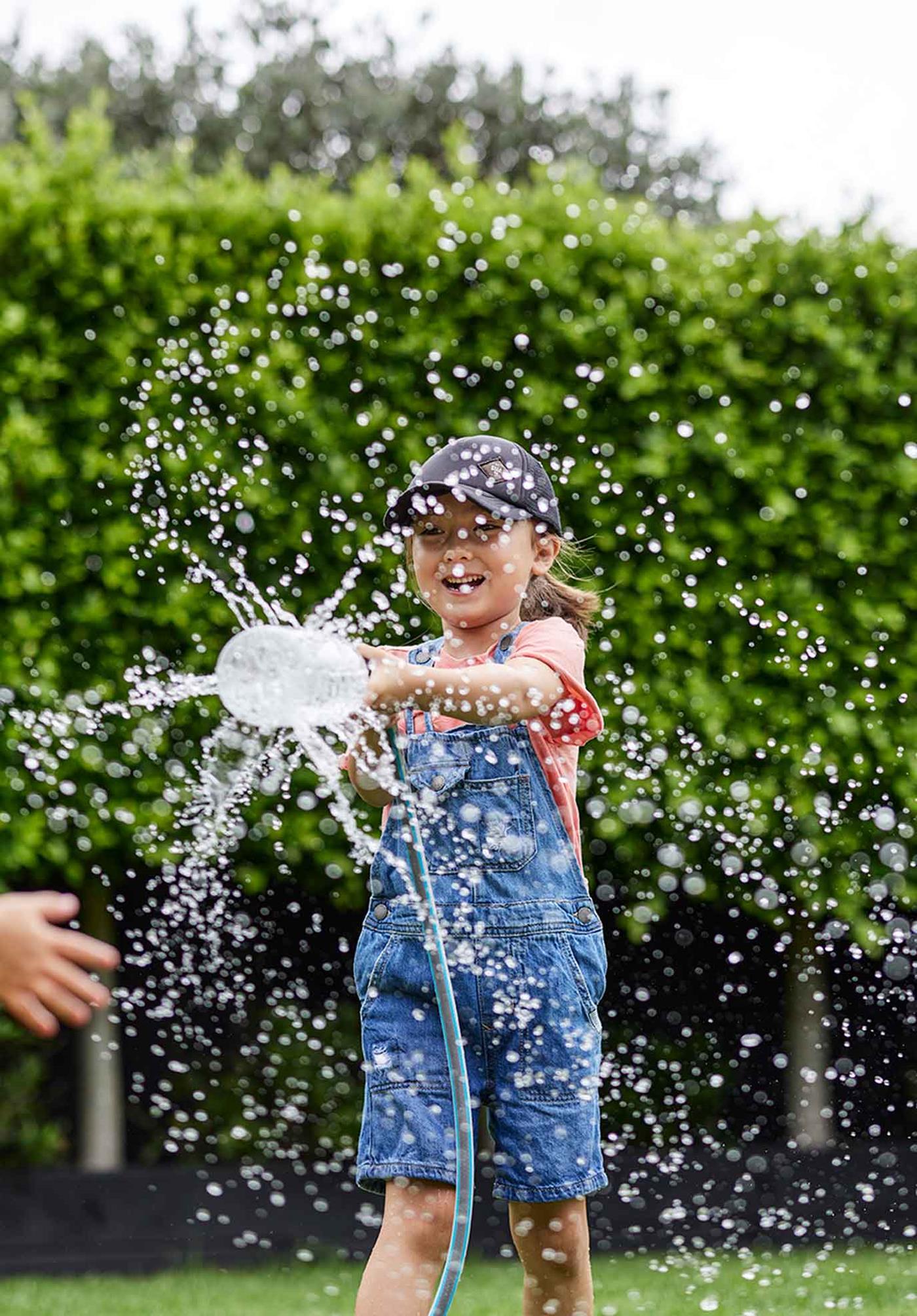 Child playing with a sprinkler