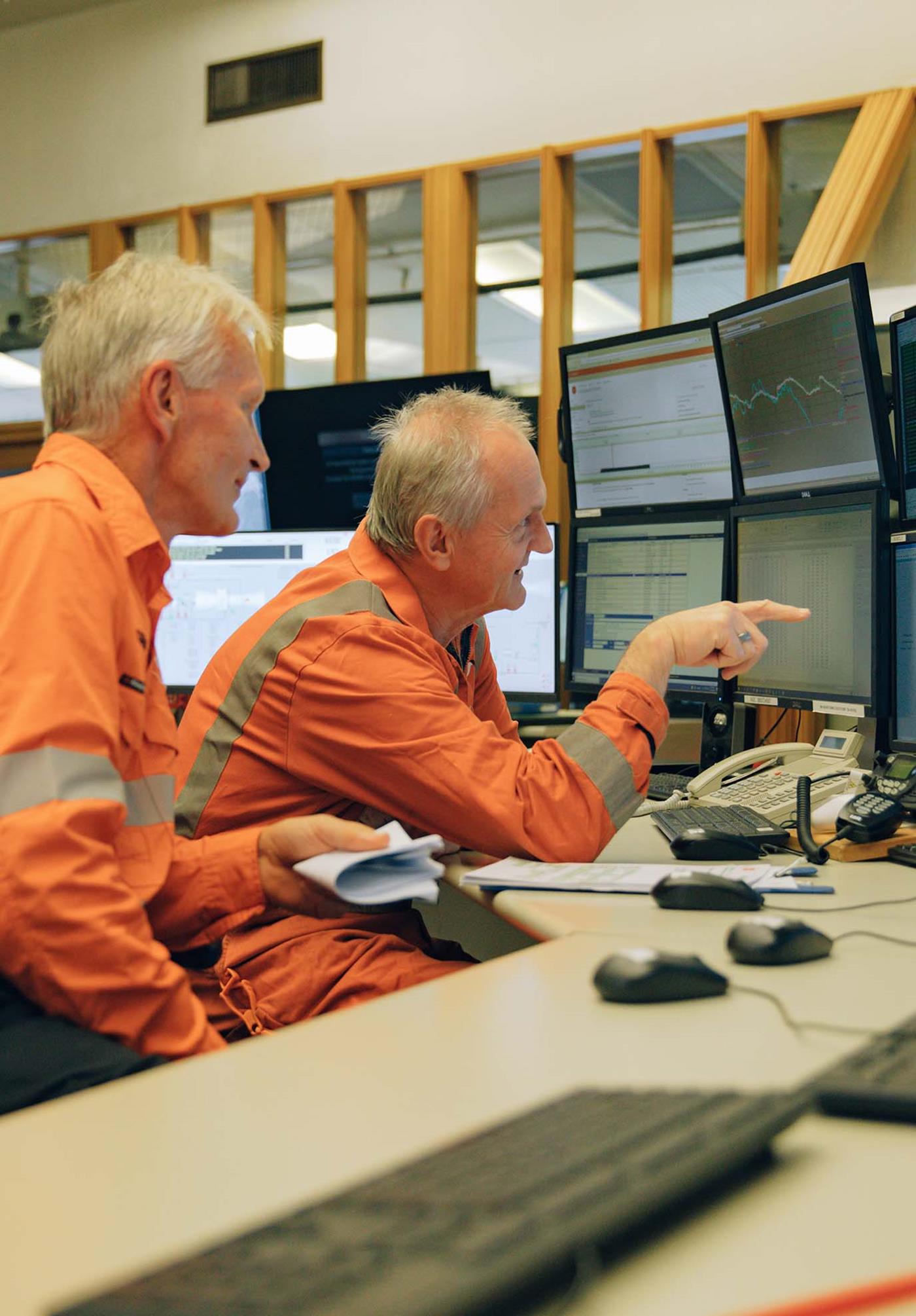 Two men in high vis generation controllers
