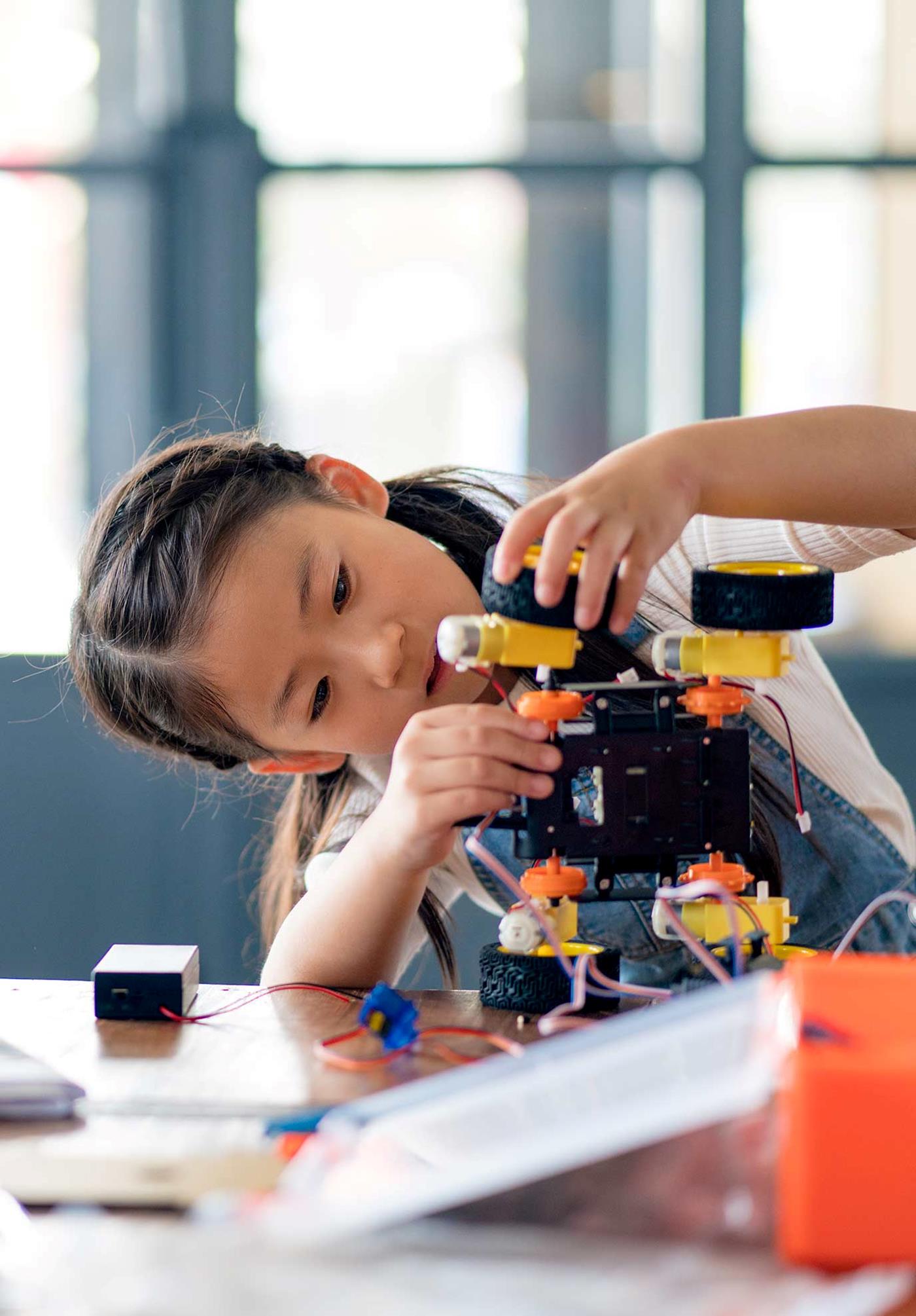 Girl building robot