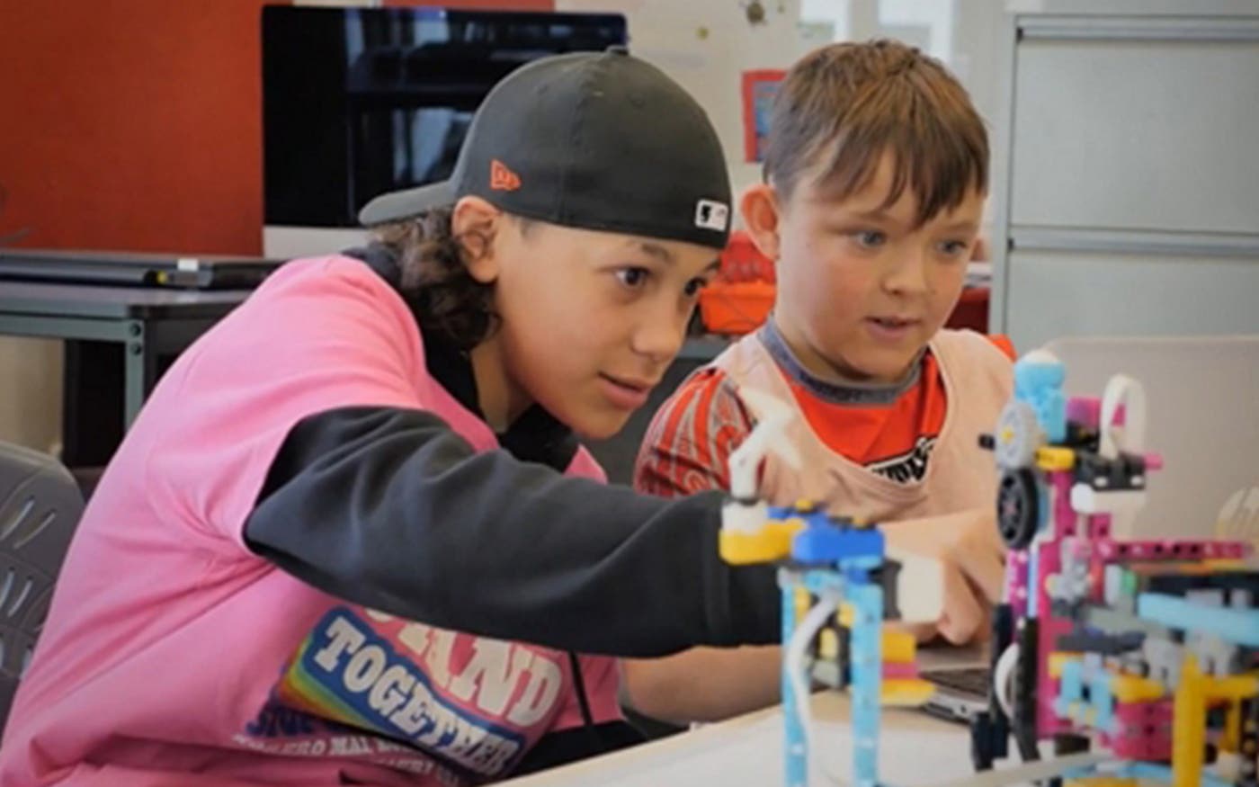 Kids at computer with robots