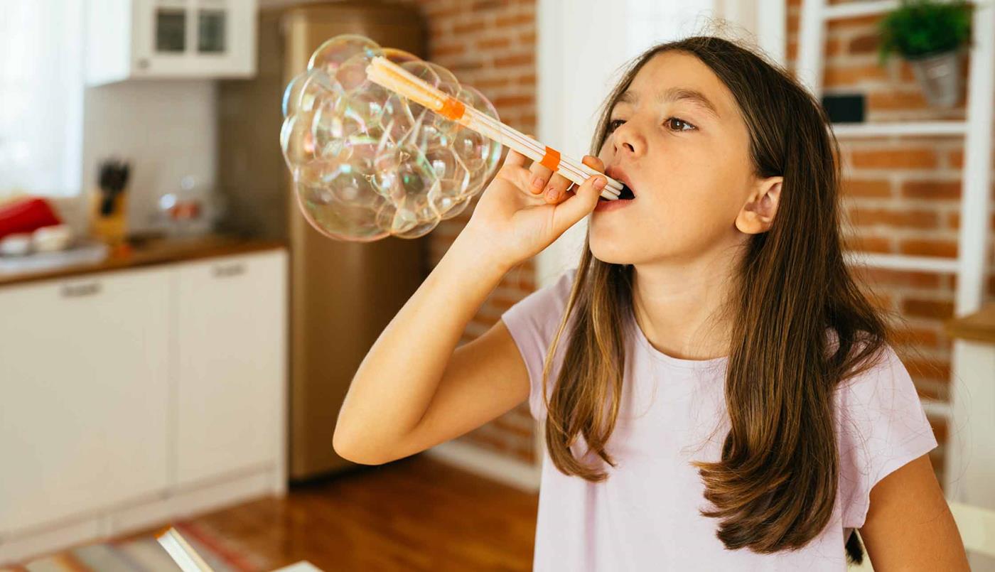girl blowing bubbles