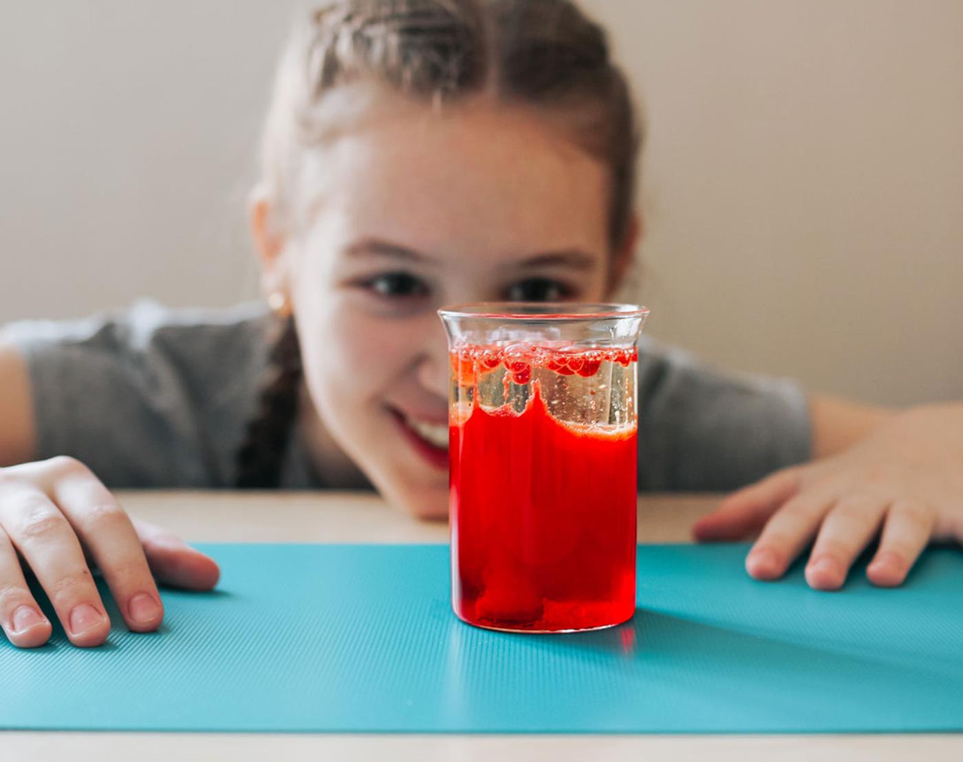 Girl looking at homemade lava lamp activity on desk