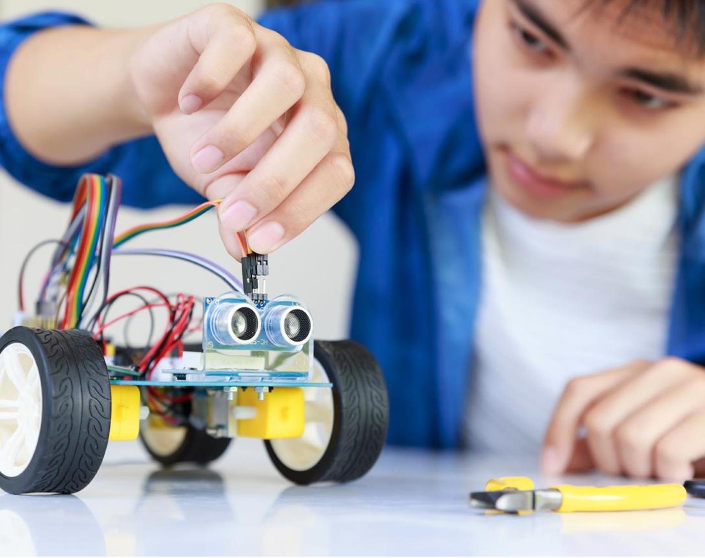 student building stem robot