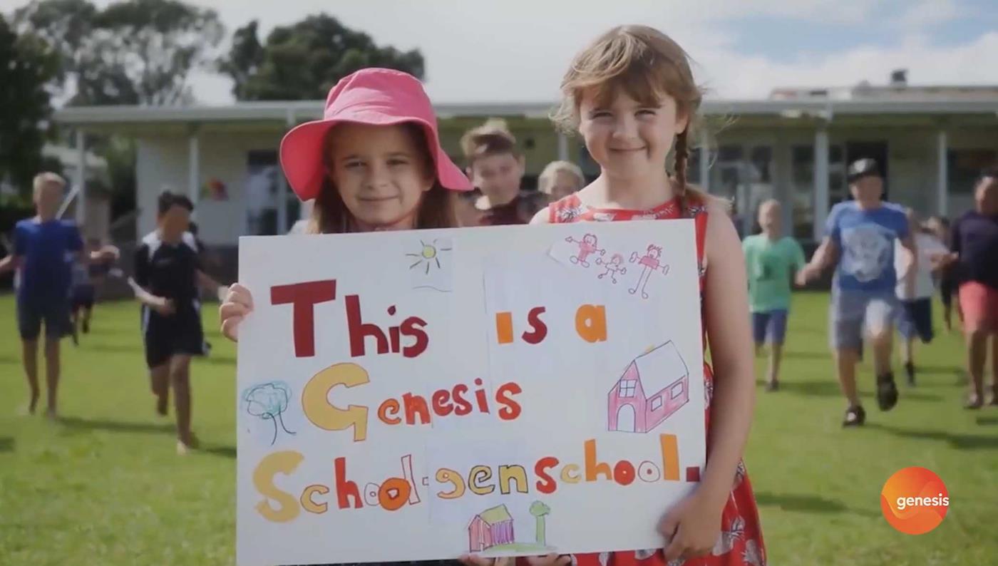 Students in playground at a School-gen school holding a sign